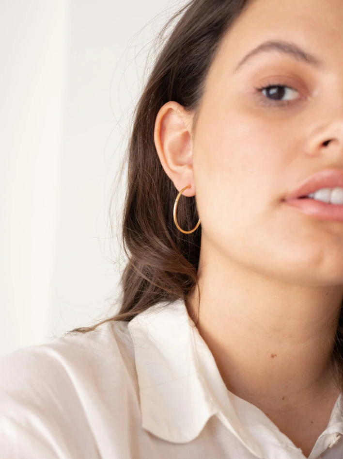 curate, laude the label, sustainable and ethically made womens fashion jewelry, gold everyday hoop earrings, simple hoop earrings, thin hoop earrings, medium sized womens hoop earrings, fashion jewelry