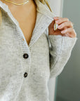 curate, poems bcn, sustainable and ethically made womens apparel and sweaters, light grey pullover sweater with buttons, roundneck sweater, soft womens sweater, sweater weather, fall and winter style, womens fashion retailer
